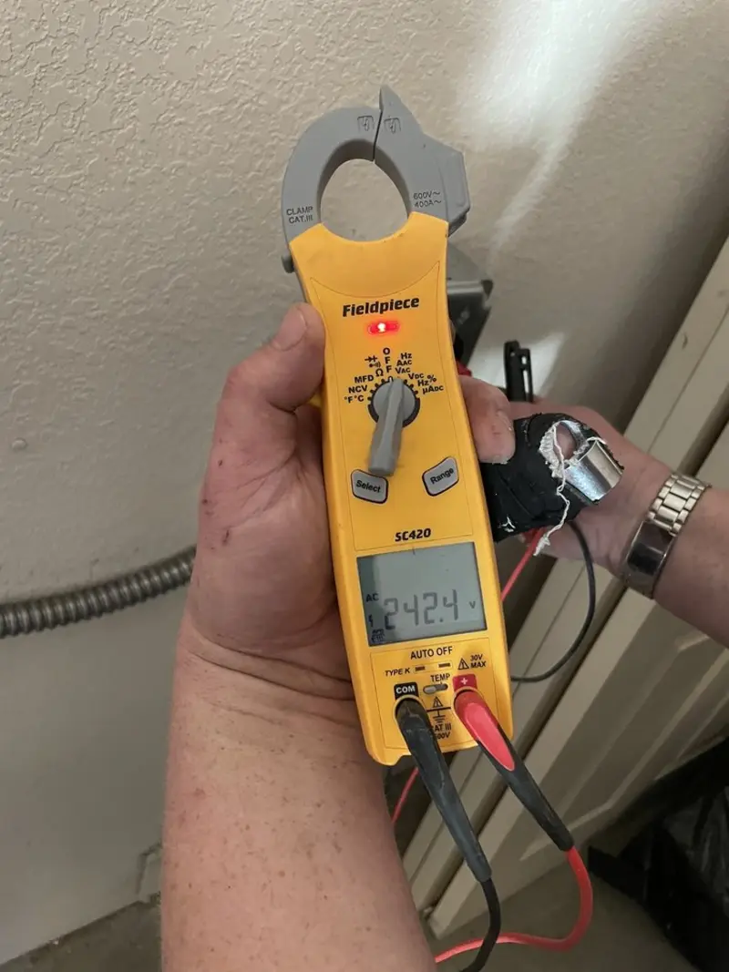 Voltage testing with clamp meter during Outlet Installation in Kendall